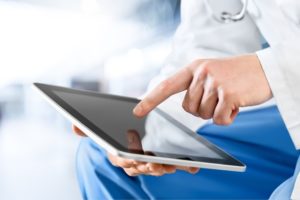 Photo of medical person with tablet