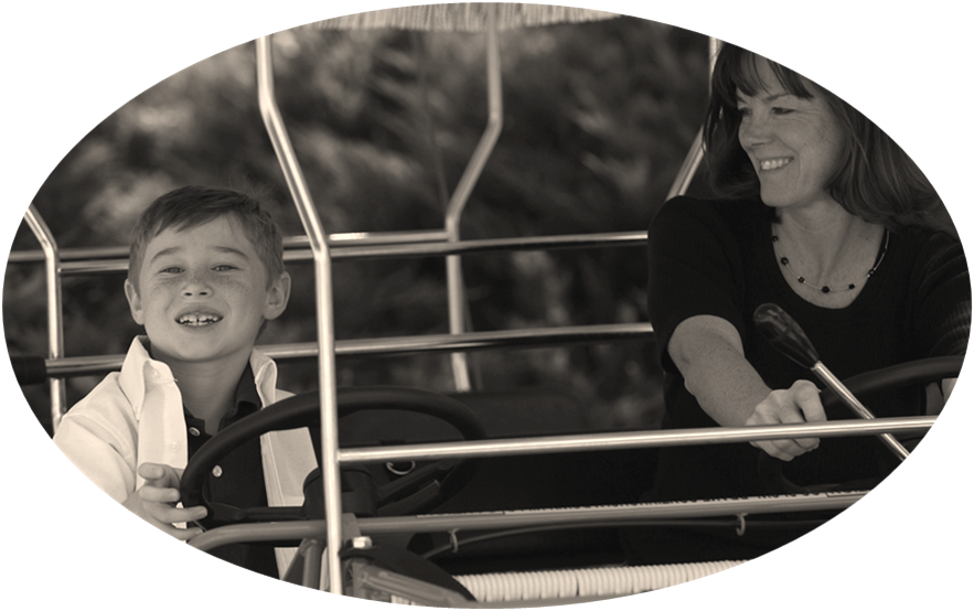 Boy with his mother in a golf cart.