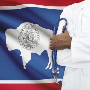 Wyoming flag with doctor holding stethoscope