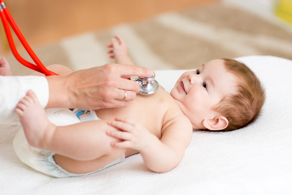 Dr listening to baby's heart with stethoscope