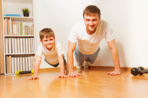 Photo of boy and dad exercising