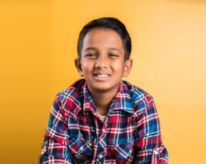 Boy in plaid shirt smiling