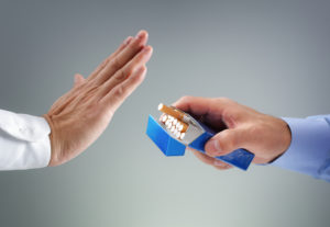 photo of hands and cigarette pack