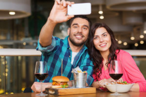 couple at restaurant taking a picture