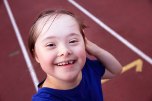 Girl on smiling on a running track