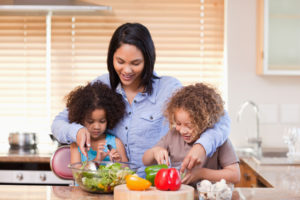 Photo of woman and kids in kitchen.
