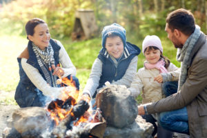 Family sitting around a campfire