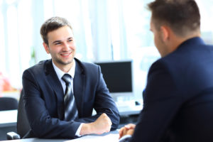 Two men sitting acrossed from each other at a job interview