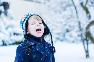 Little boy playing in snow