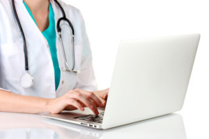 medical person with laptop