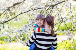 Mom and child in blossum tree
