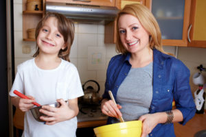 Photo of kid and mom cooking