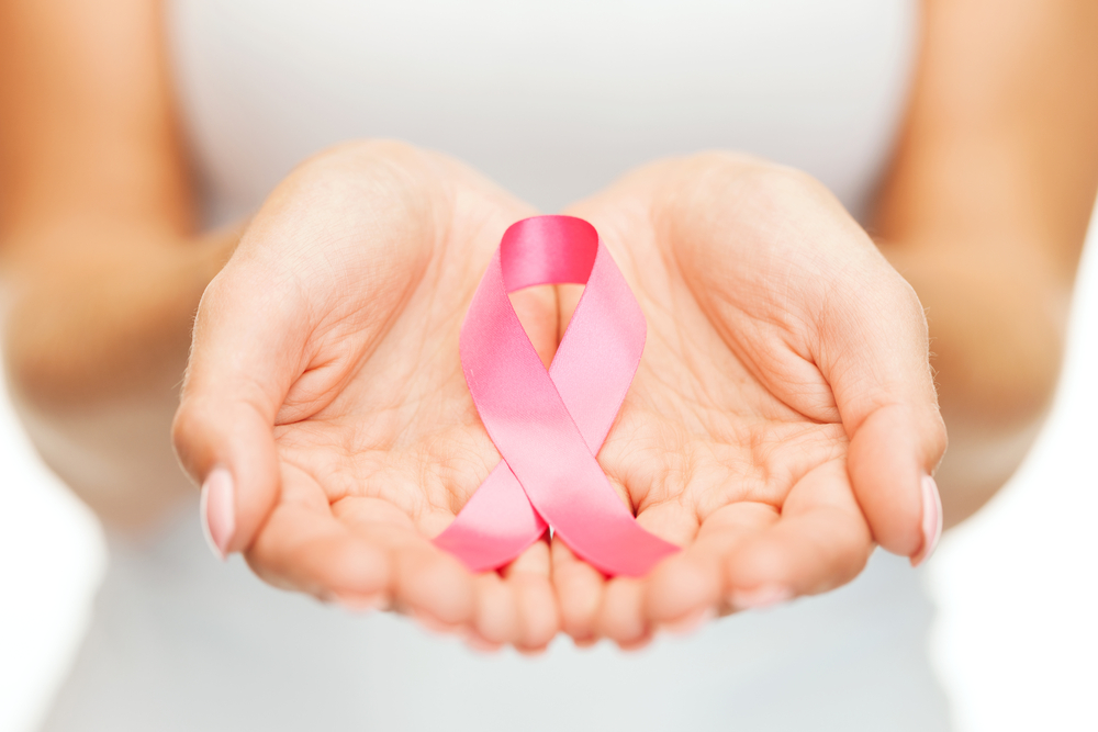 photo of pink ribbon in hands