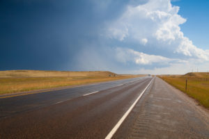 photo of road with clouds