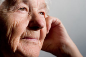 senior man with hand on face