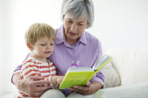 Senior reading to child