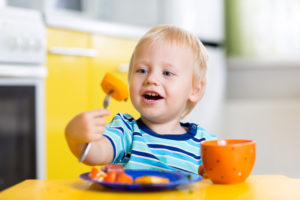 Photo of toddler eating fruit