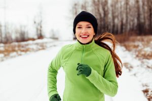 Photo of woman running in snow