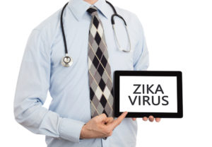 Photo of medical person with tablet saying Zika