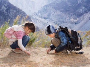 Two kids hiking in the mountains