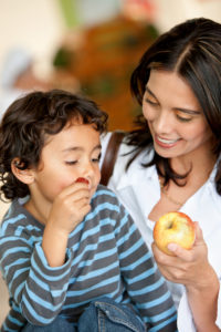 mom with son eating apples