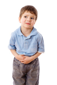 Photo of sick boy holding tummy