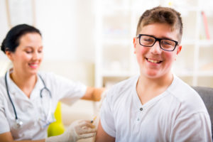teen getting vaccine shot from a doctor or nurse