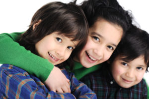 photo of 3 kids smiling