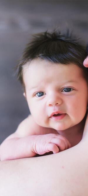 baby on father&rsquo;s shoulder