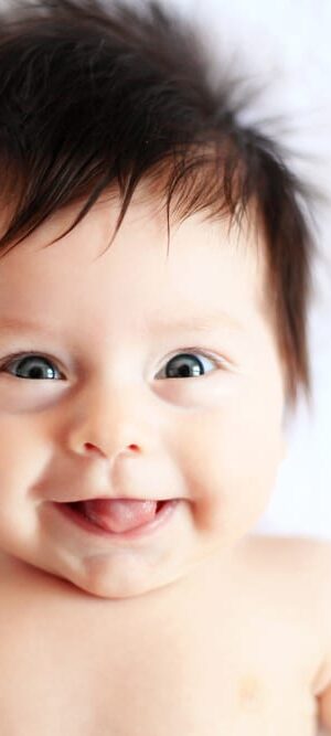 baby with crazy hair on blanket