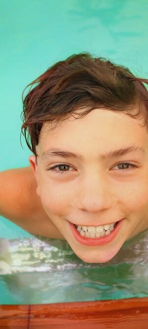 boy getting out of pool