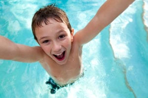 boy jumping in pool