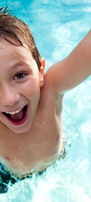 boy jumping in pool