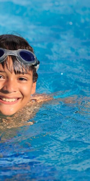 boy with goggles in pool
