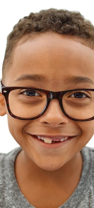 boy with missing teeth and big glasses