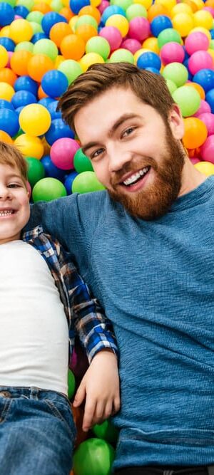 dad and boy in ball pit