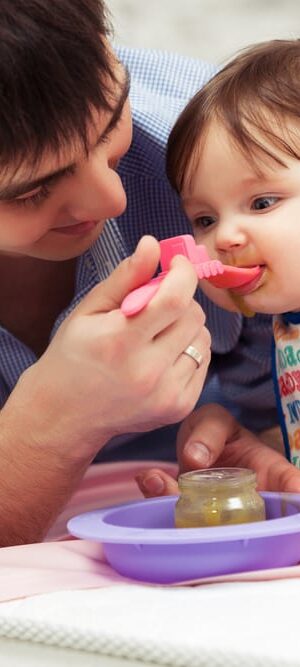 dad feeding baby