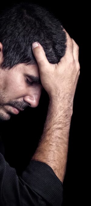 depressed man holding head