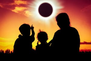 photo of family with eclipse