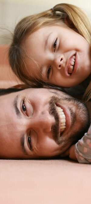 father and daughter smiling