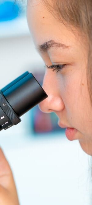 girl looking in microscope