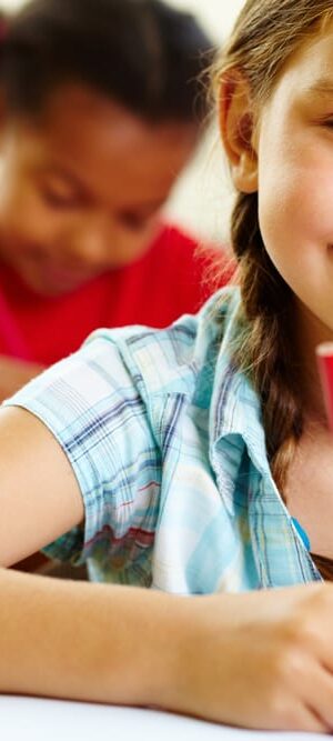 girl writing at desk
