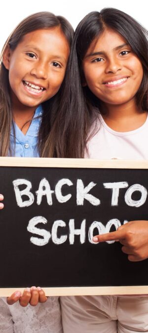girls with back to school chalkboard
