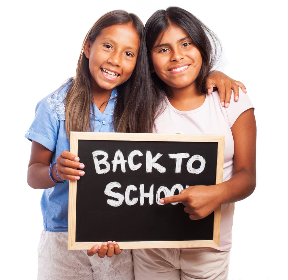 girls with back to school sign