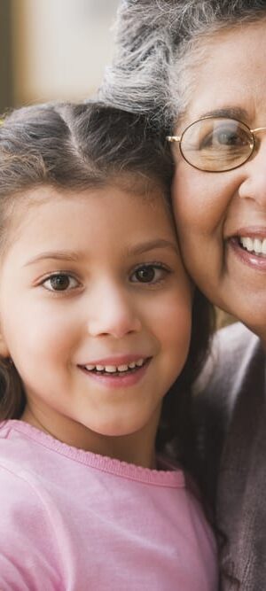 grandma hugging young girl