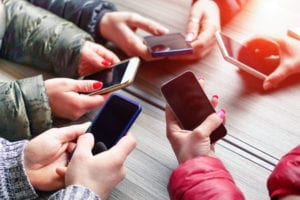 teens holding phones