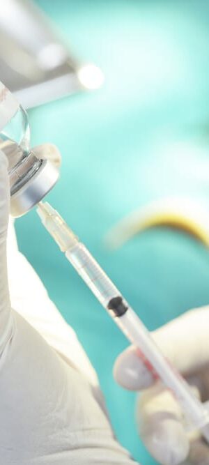 hands filling syringe