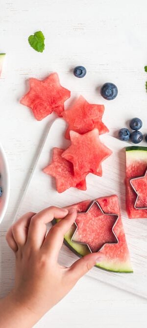 hands with fruit salad