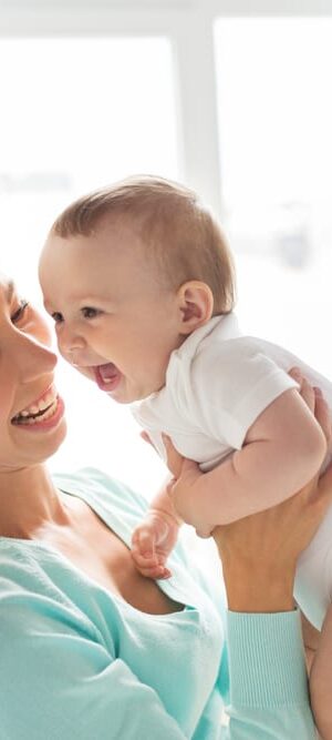 happy mom holding baby