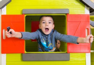 little boy in playhouse